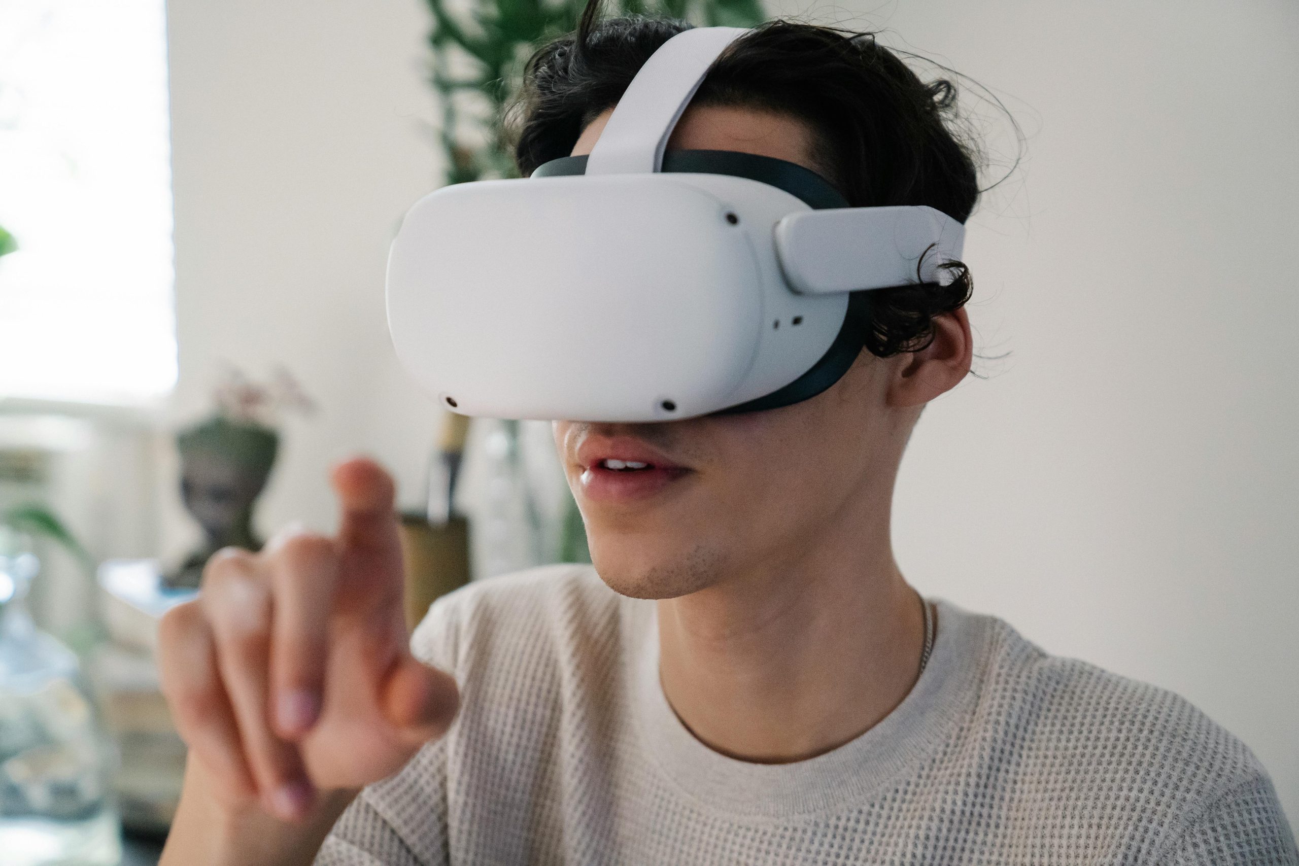 A man immersed in a virtual reality experience, wearing a sleek VR headset, showcasing modern technology in action.