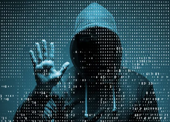 A hooded figure against a backdrop of binary code, symbolizing cybersecurity and hacking.