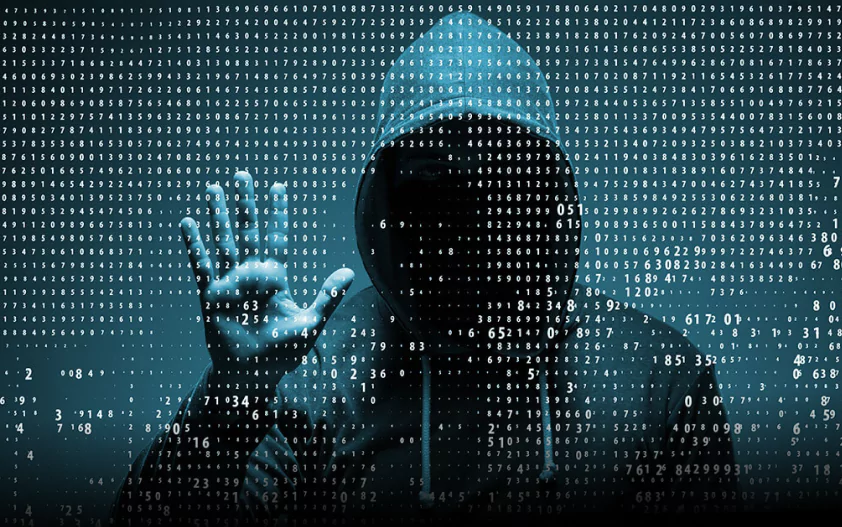 A hooded figure against a backdrop of binary code, symbolizing cybersecurity and hacking.